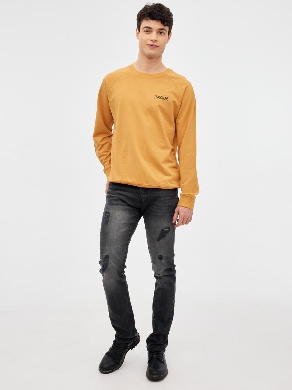 In side Jeans slim con rotos negros