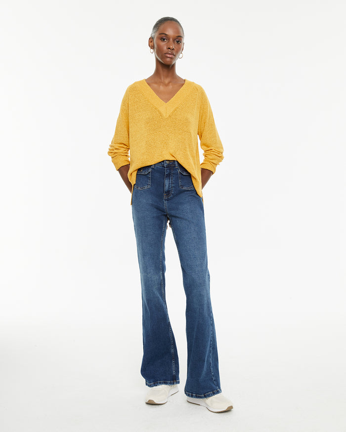 system action Jeans fit flare tiro medio detalle bolsillos delanteros