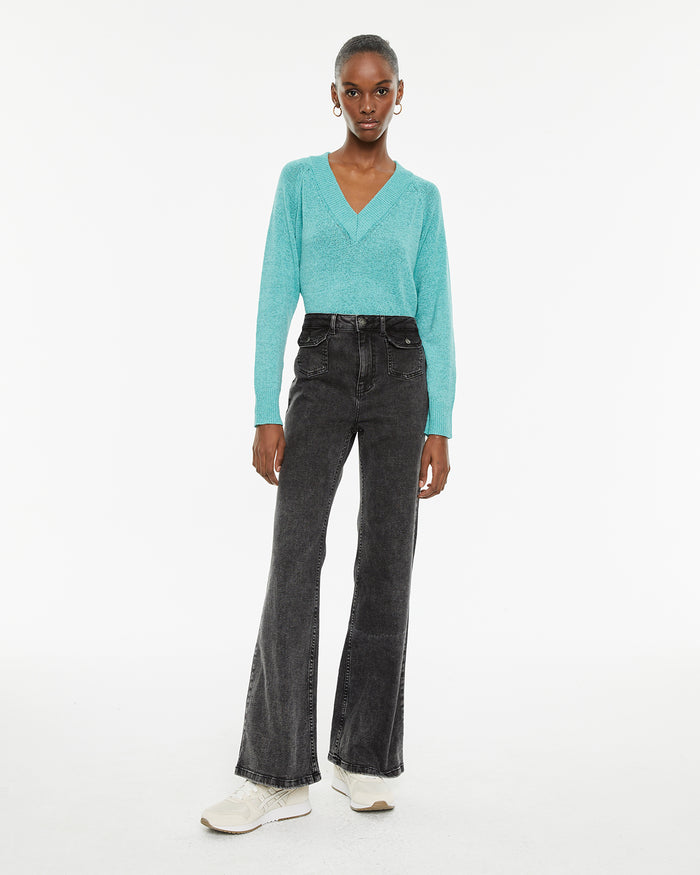 system action Jeans fit flare tiro medio detalle bolsillos delanteros