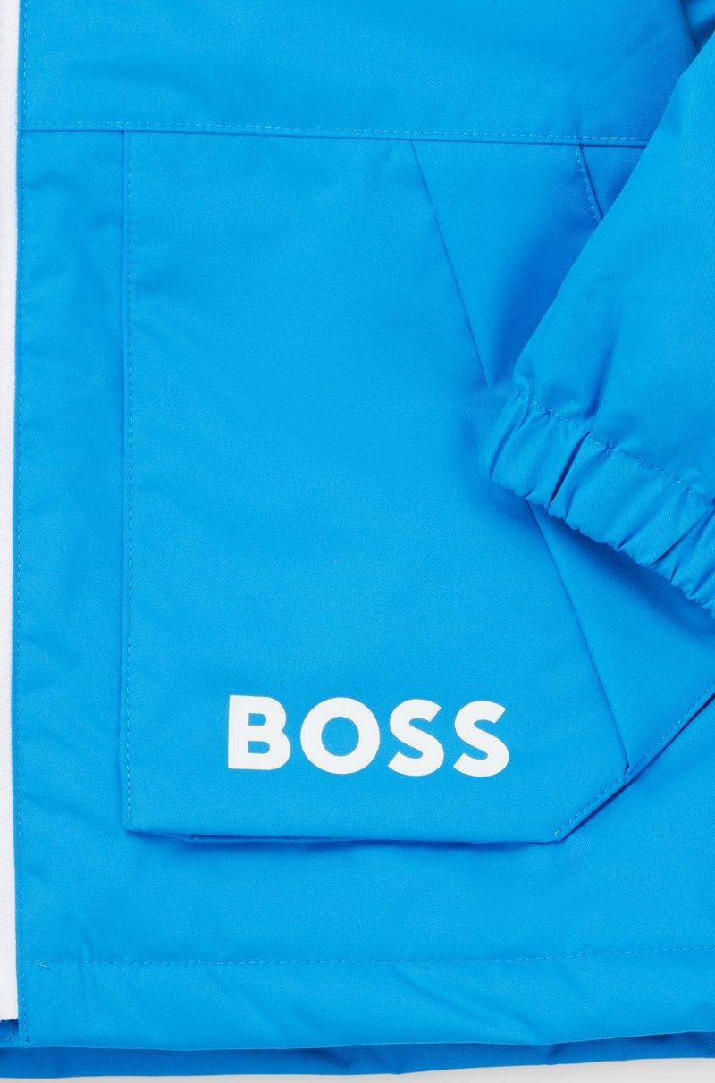 Hugo Boss Cazadora Cortavientos Con Capucha Para Niños Con Estampado De Monogramas Que Aparece Con Agua